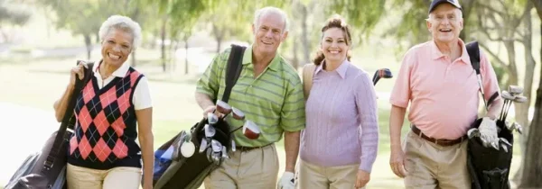 Chiropractic Charles IL Adults enjoying a round of golf outdoors on a sunny day
